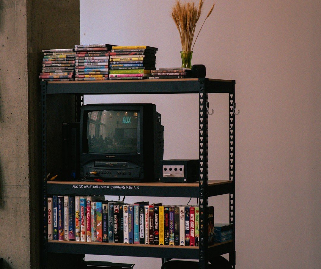 13. Shelves Loaded With DVDs and Old Tech (Image Credits: Unsplash)